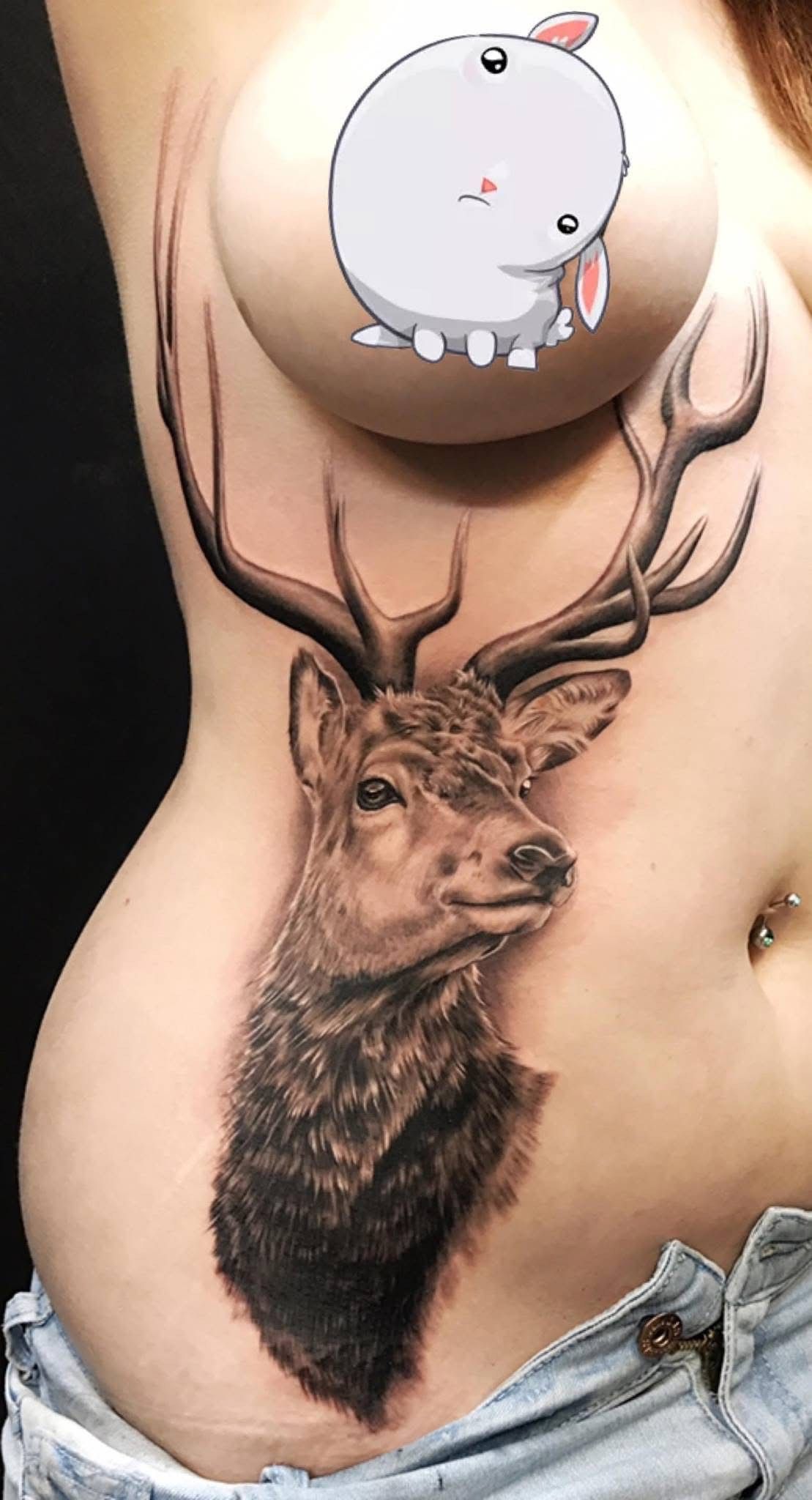 Tattoo of a deer on a person's torso. A cartoon bunny covers one breast. — Whitsunday Tattooing Airlie Beach in Whitsundays, QLD