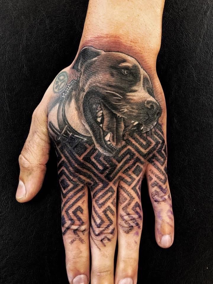 Hand tattoo with a dog head and geometric design. — Whitsunday Tattooing Airlie Beach in Whitsundays, QLD