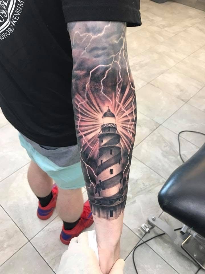 Tattoo of a Lighthouse With a Bright Light Surrounded by Lightning — Whitsunday Tattooing Airlie Beach in Airlie Beach, QLD
