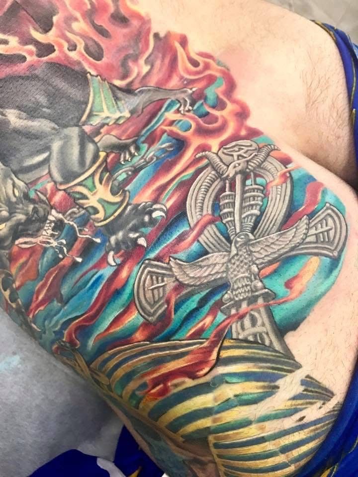 Colorful tattoo of Anubis and an ankh symbol with flames on skin. — Whitsunday Tattooing Airlie Beach in Whitsundays, QLD