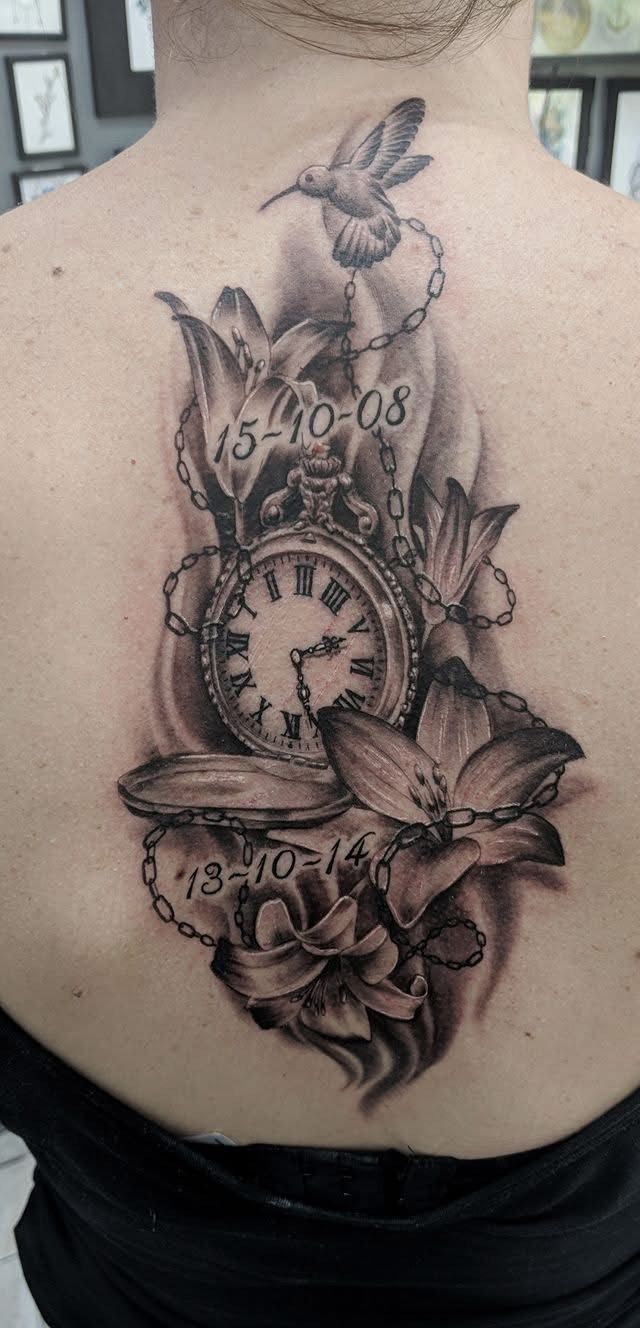 Tattoo of a pocket watch, flowers, a hummingbird, and dates on a back. — Whitsunday Tattooing Airlie Beach in Whitsundays, QLD