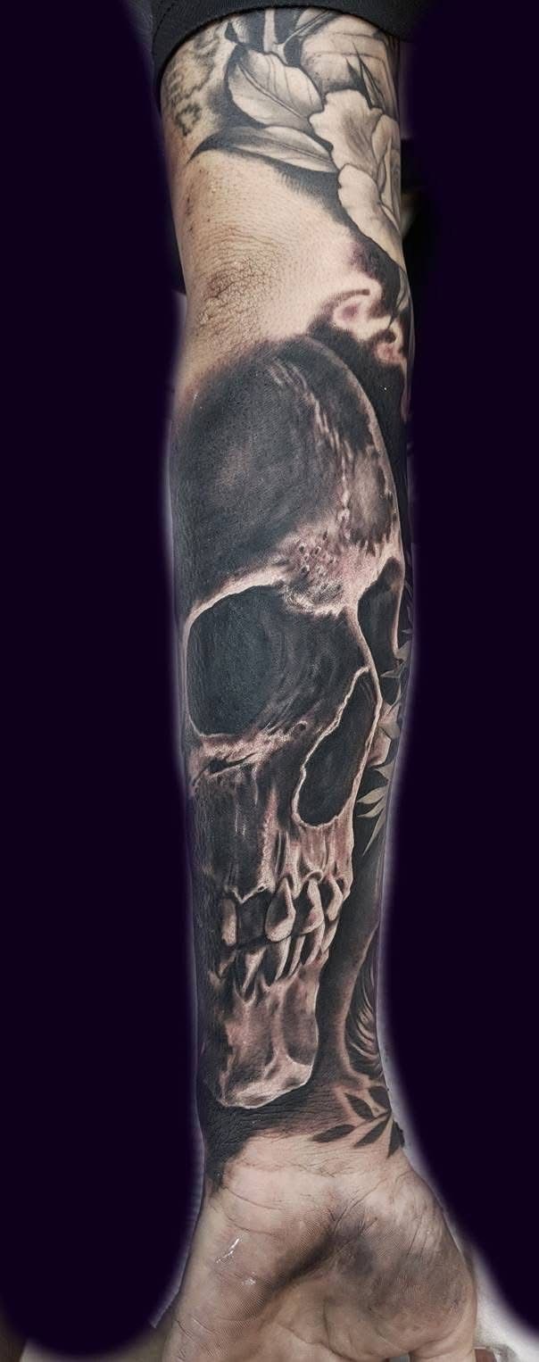 Tattoo of a skull on an arm. The skull is shaded with dark and light tones. — Whitsunday Tattooing Airlie Beach in Whitsundays, QLD