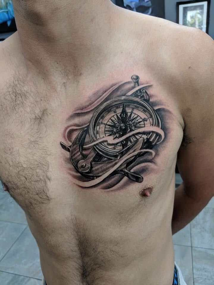 Chest tattoo: compass and ship's wheel with shaded details. — Whitsunday Tattooing Airlie Beach in Whitsundays, QLD