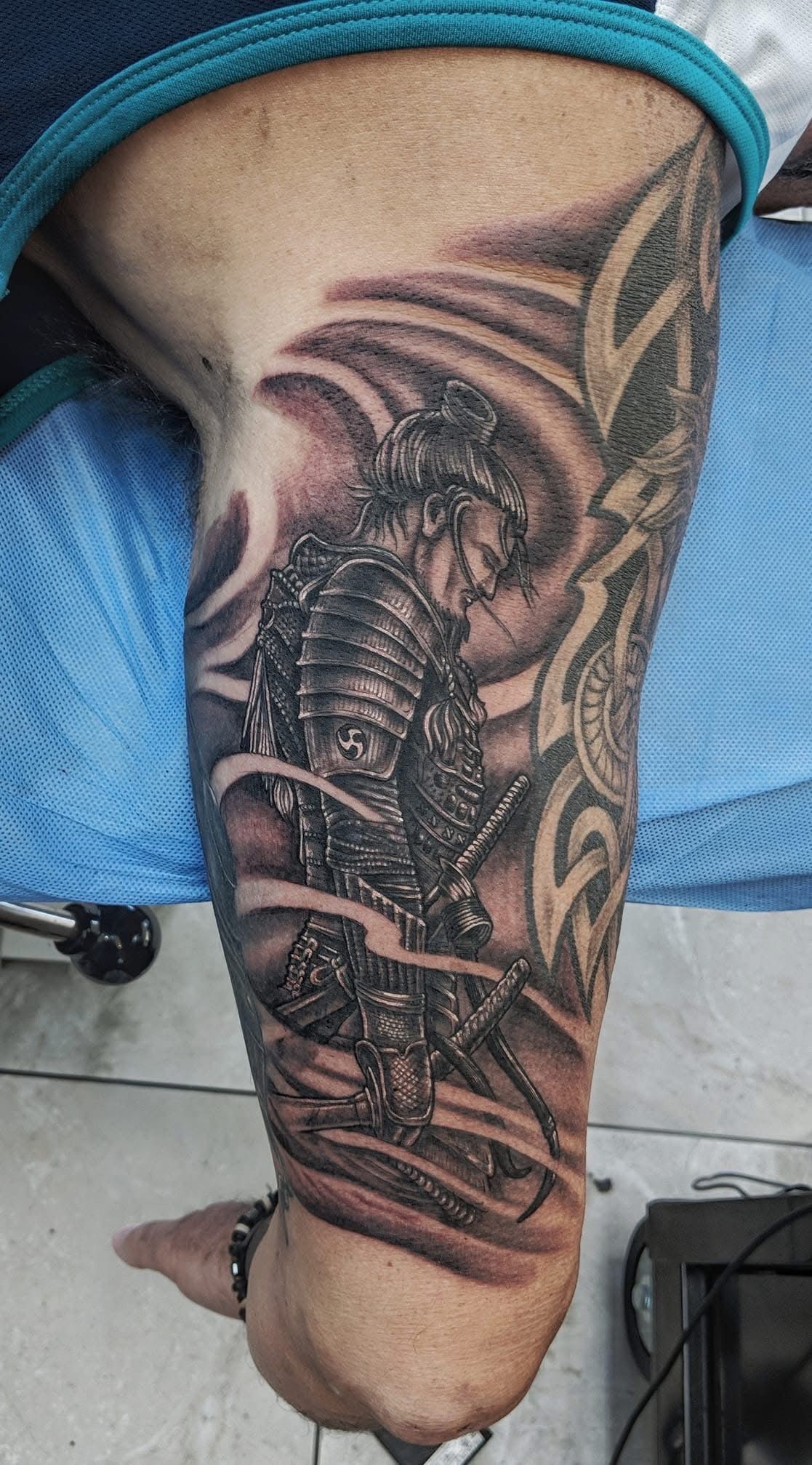 Tattoo of a samurai in armor with swirling clouds, on a person's forearm. — Whitsunday Tattooing Airlie Beach in Whitsundays, QLD