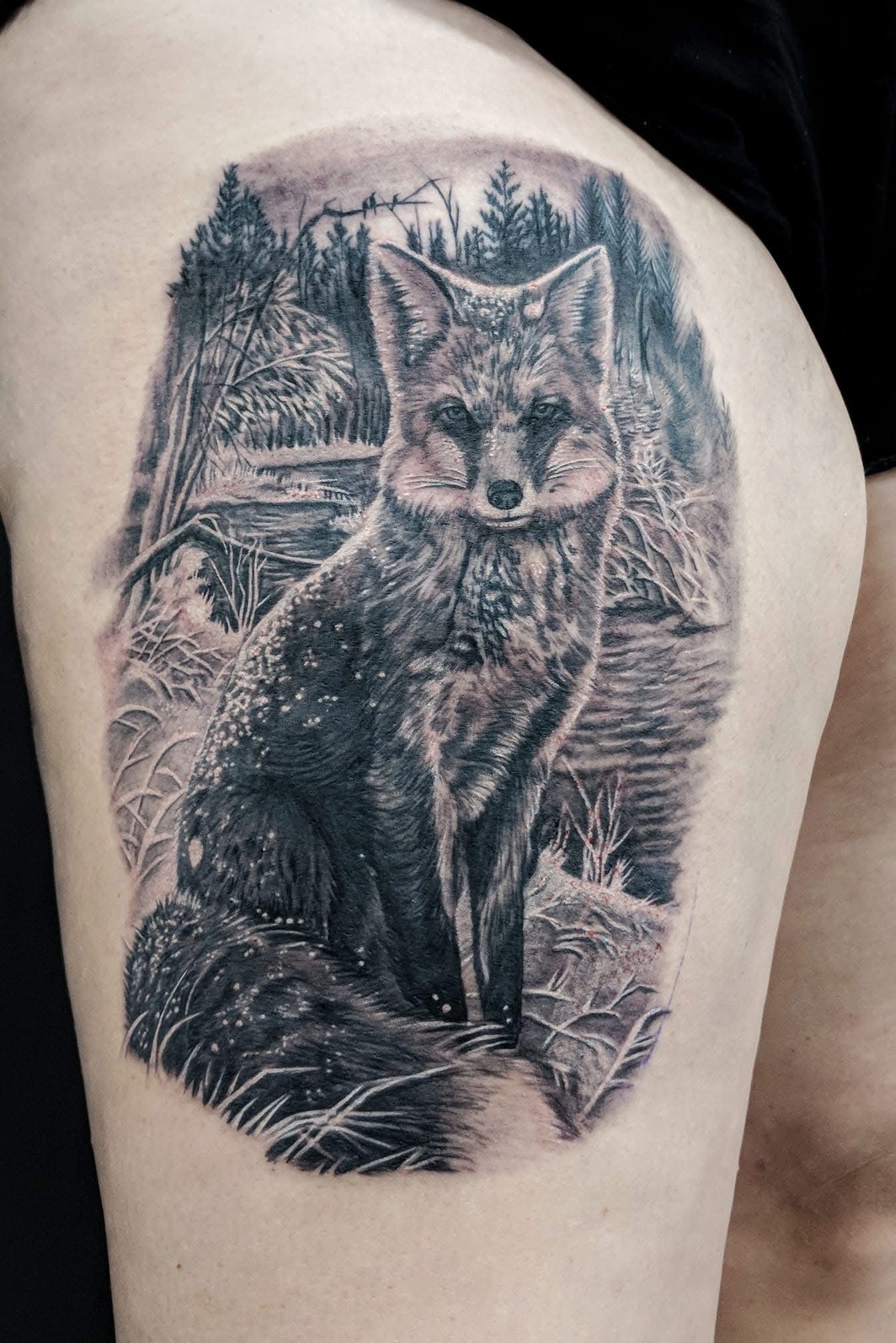Tattoo of a seated fox in a snowy forest, with cabin and trees in the background, in black and white. — Whitsunday Tattooing Airlie Beach in Whitsundays, QLD