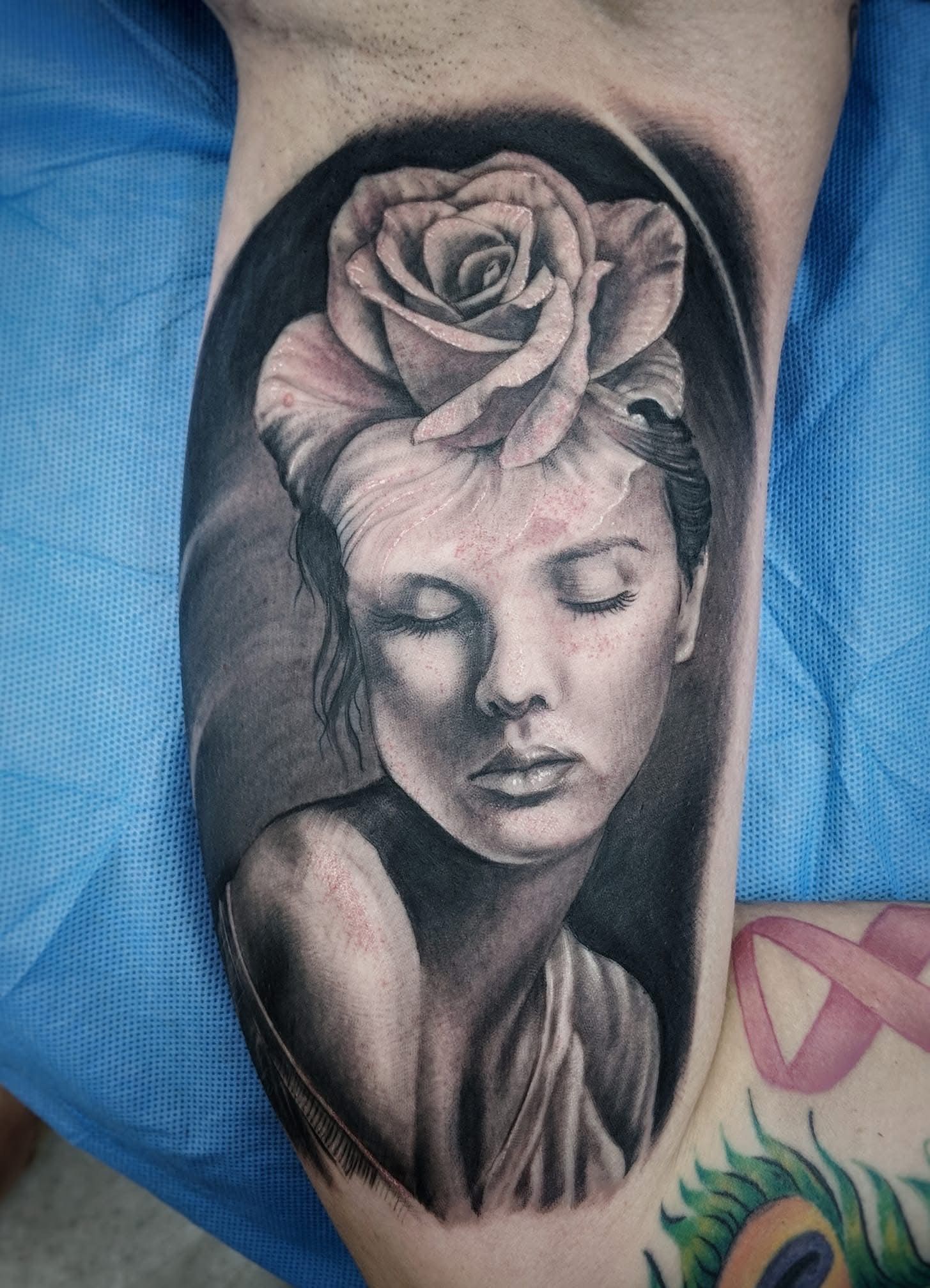 Black and white tattoo of a woman with a rose atop her head, arm view. — Whitsunday Tattooing Airlie Beach in Whitsundays, QLD