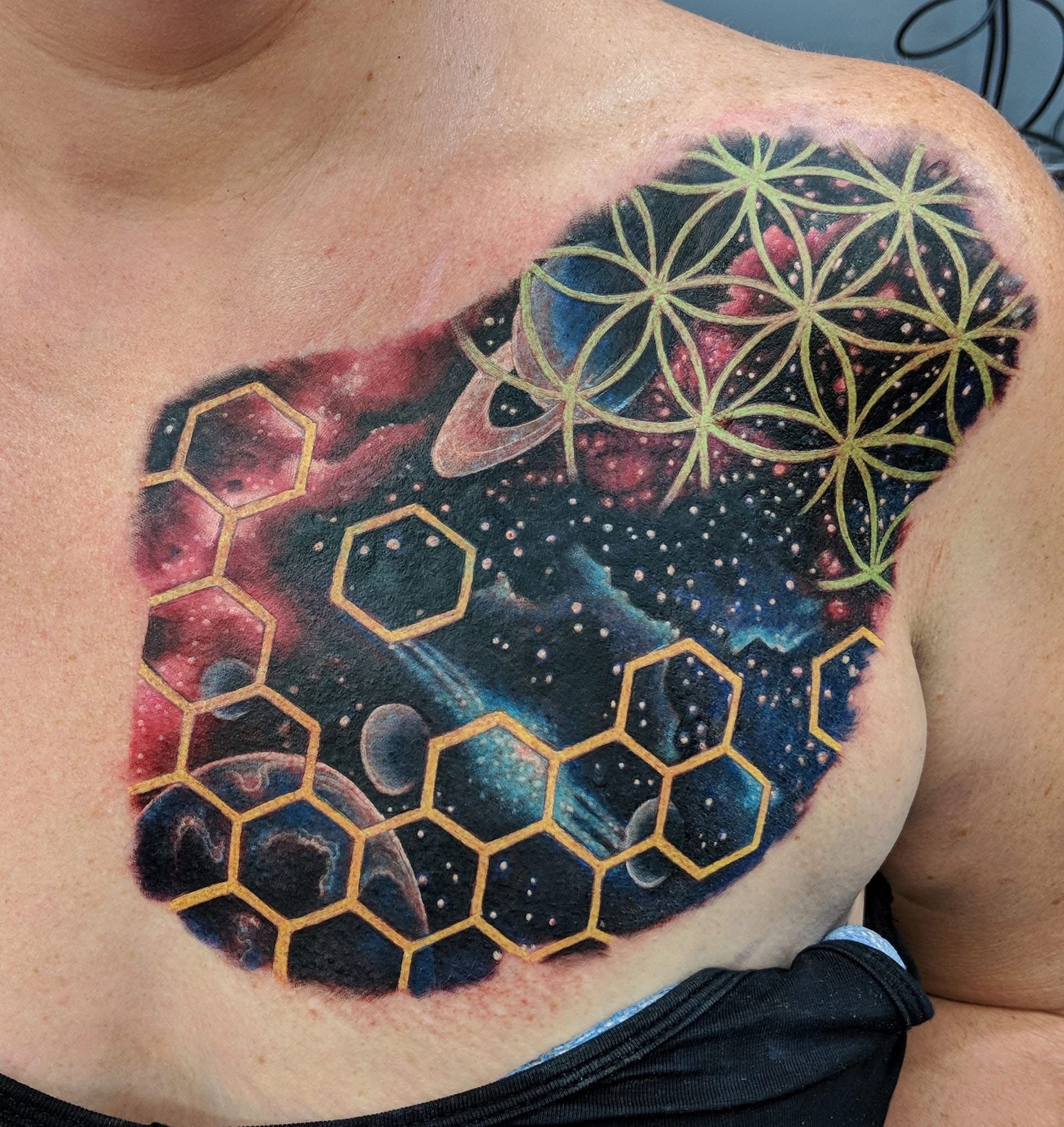 Tattoo of a space scene with planets, stars, and geometric shapes on a person's chest. — Whitsunday Tattooing Airlie Beach in Whitsundays, QLD
