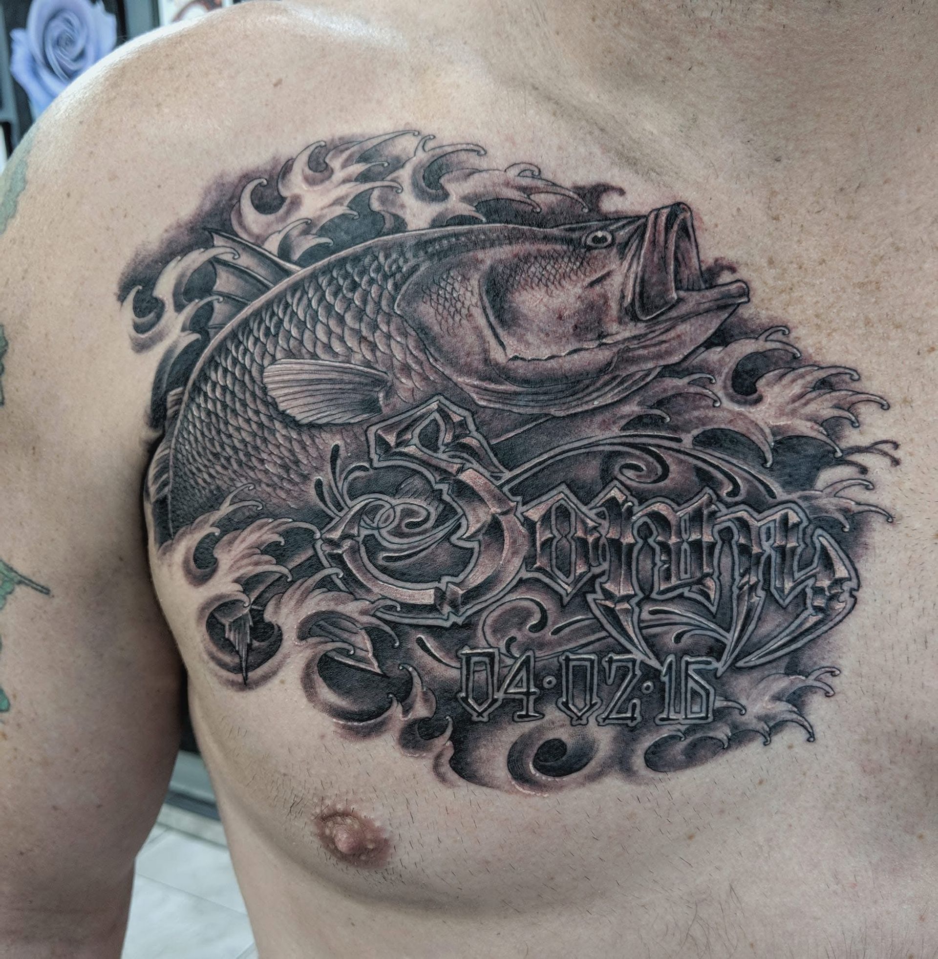 Tattoo of a largemouth bass with open mouth surrounded by stylized water and lettering with the date 04/07/16. — Whitsunday Tattooing Airlie Beach in Whitsundays, QLD