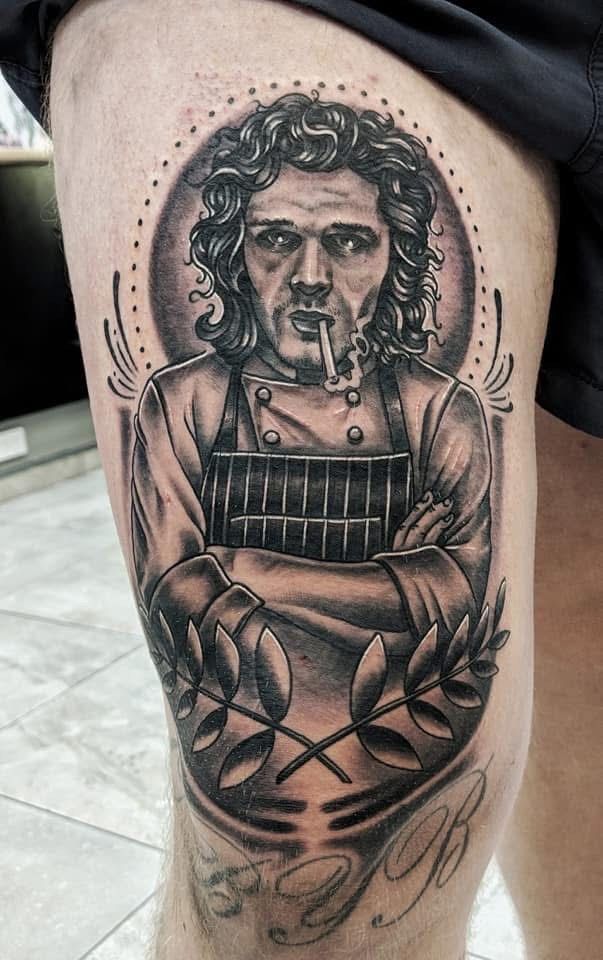 Tattoo of a chef with crossed arms, smoking a cigarette, surrounded by laurel and a dotted circle. — Whitsunday Tattooing Airlie Beach in Whitsundays, QLD