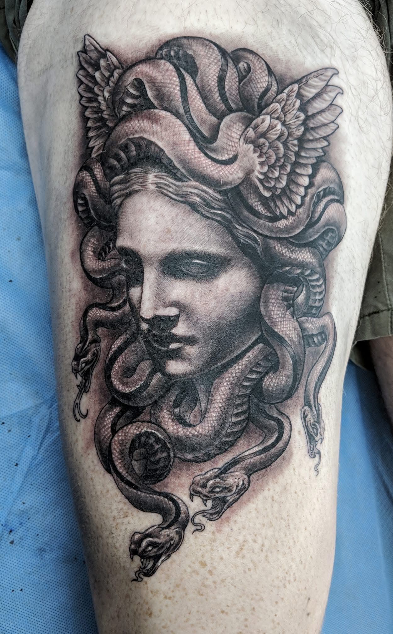 Tattoo of Medusa's Face With Snakes for Hair and Winged Headwear — Whitsunday Tattooing Airlie Beach in Airlie Beach, QLD