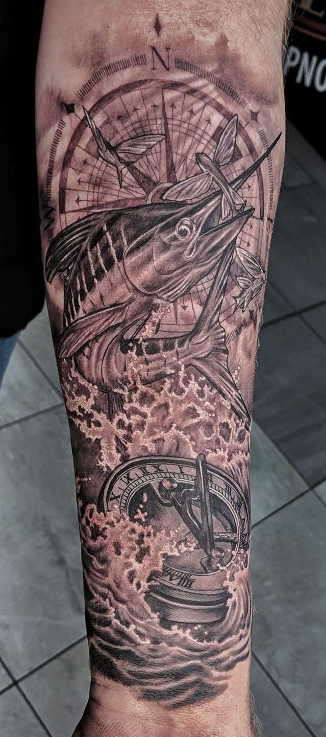 Tattoo of marlin fish and compass on a forearm, with detailed waves in black and gray ink. — Whitsunday Tattooing Airlie Beach in Whitsundays, QLD