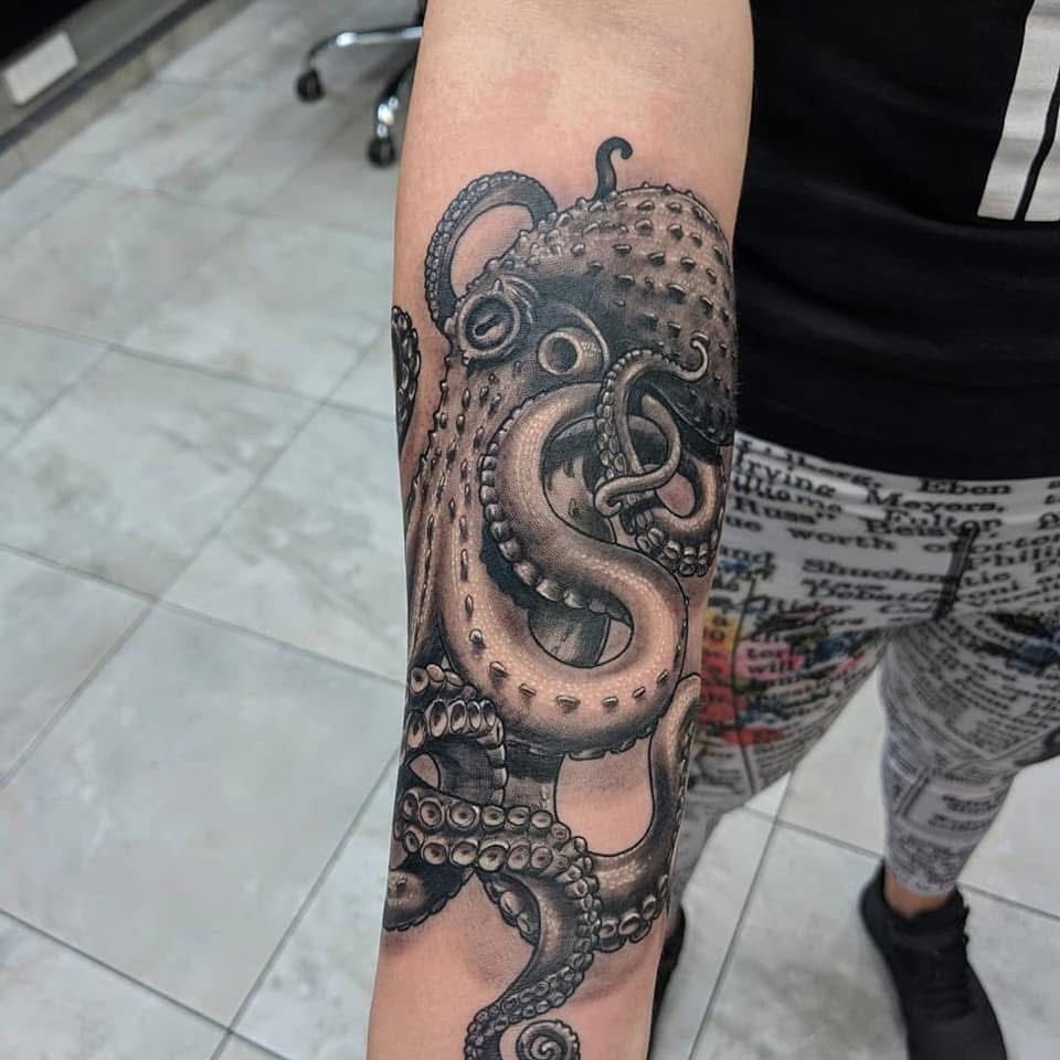 Black and gray octopus tattoo on a forearm. — Whitsunday Tattooing Airlie Beach in Whitsundays, QLD