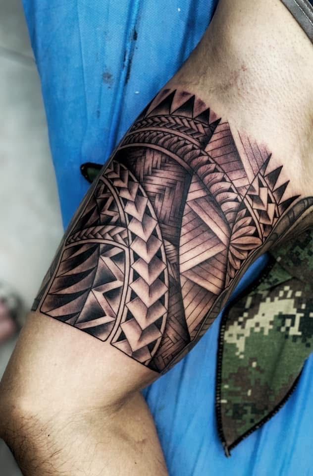 Black tribal tattoo on a person's thigh, covering a significant area with geometric patterns. — Whitsunday Tattooing Airlie Beach in Whitsundays, QLD