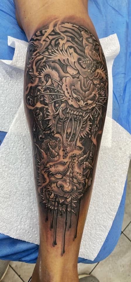Black and gray detailed tattoo on the lower leg, possibly depicting a creature with an intricate design. — Whitsunday Tattooing Airlie Beach in Whitsundays, QLD