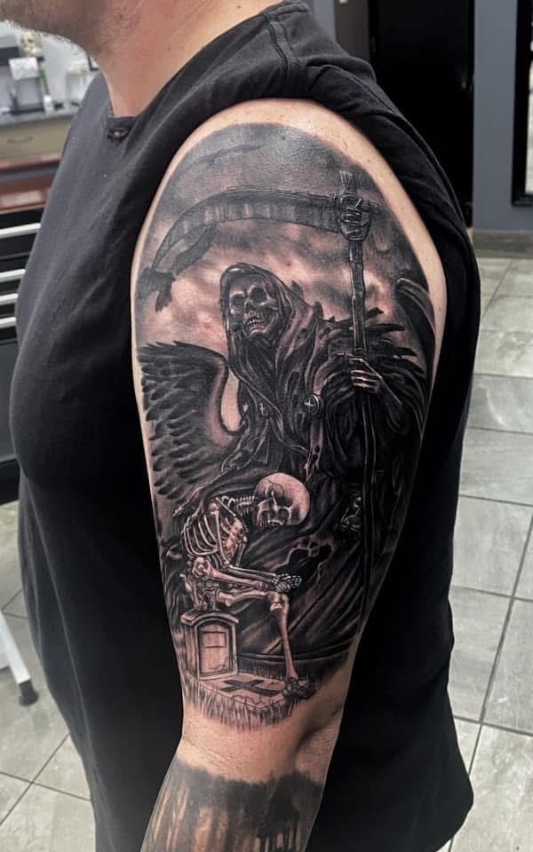 Tattoo of Grim Reaper with scythe, wings, and skeleton on arm. Monochrome with shading. — Whitsunday Tattooing Airlie Beach in Whitsundays, QLD