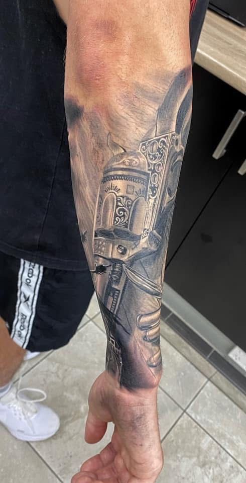 Tattoo of a Star Wars themed sleeve on a person's forearm, featuring R2-D2 and other imagery in grayscale. — Whitsunday Tattooing Airlie Beach in Whitsundays, QLD