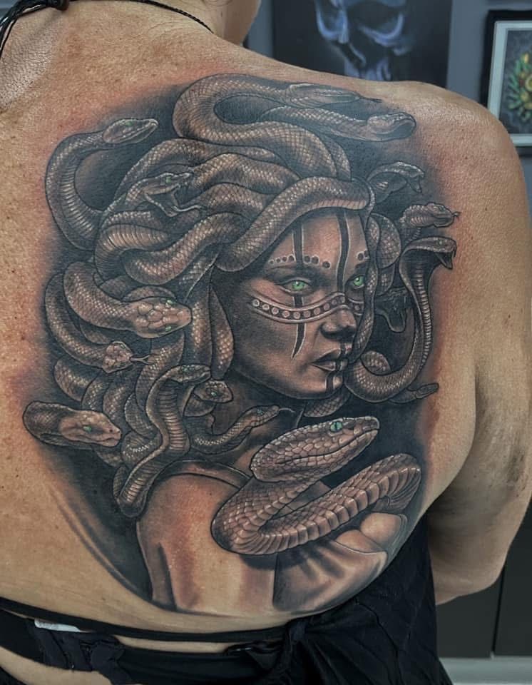 Tattoo of Medusa on a person's back. Black and gray design with snakes and detailed face. — Whitsunday Tattooing Airlie Beach in Whitsundays, QLD