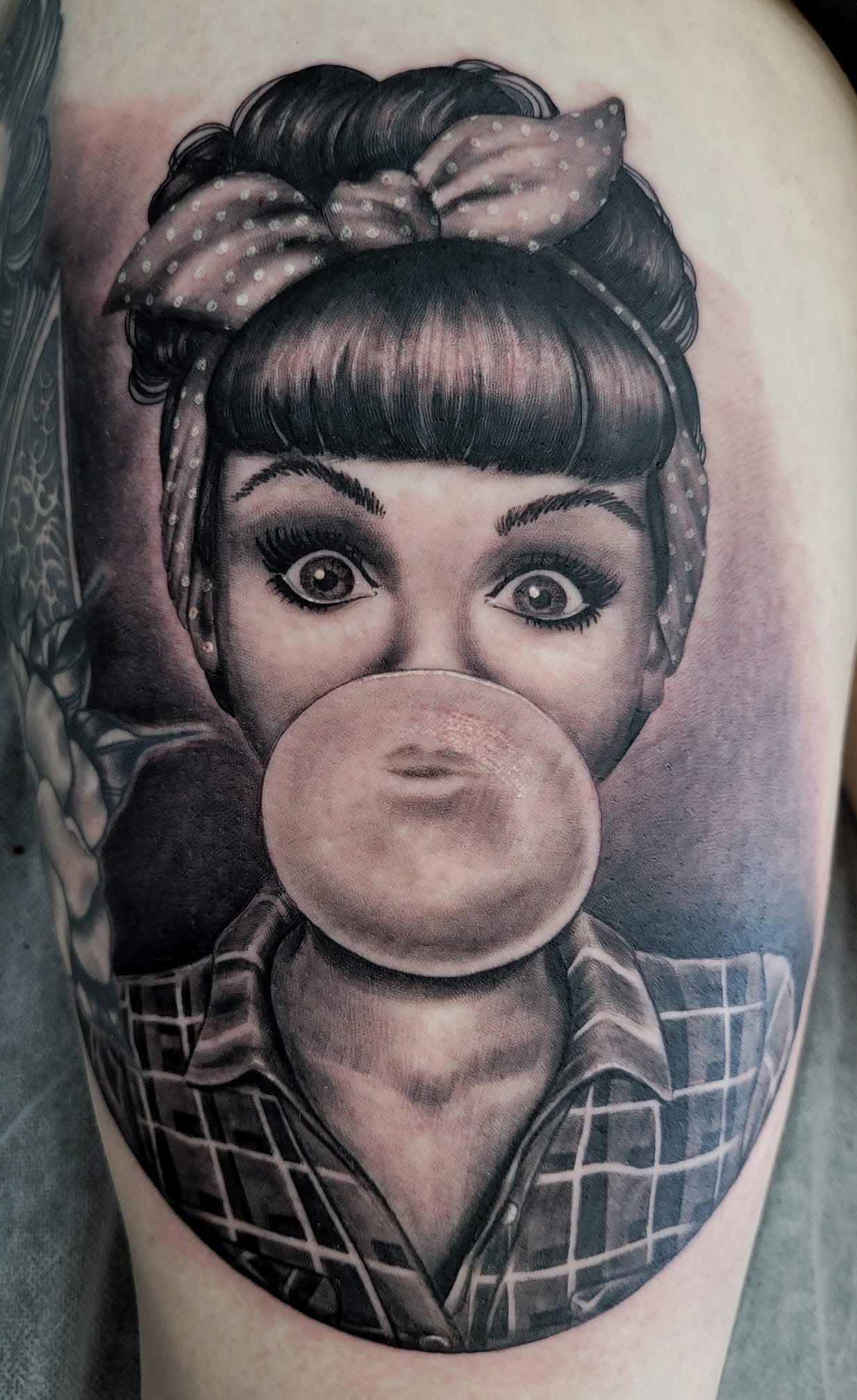 Black and white tattoo of a woman blowing a bubble. She wears a headscarf and plaid shirt. — Whitsunday Tattooing Airlie Beach in Whitsundays, QLD