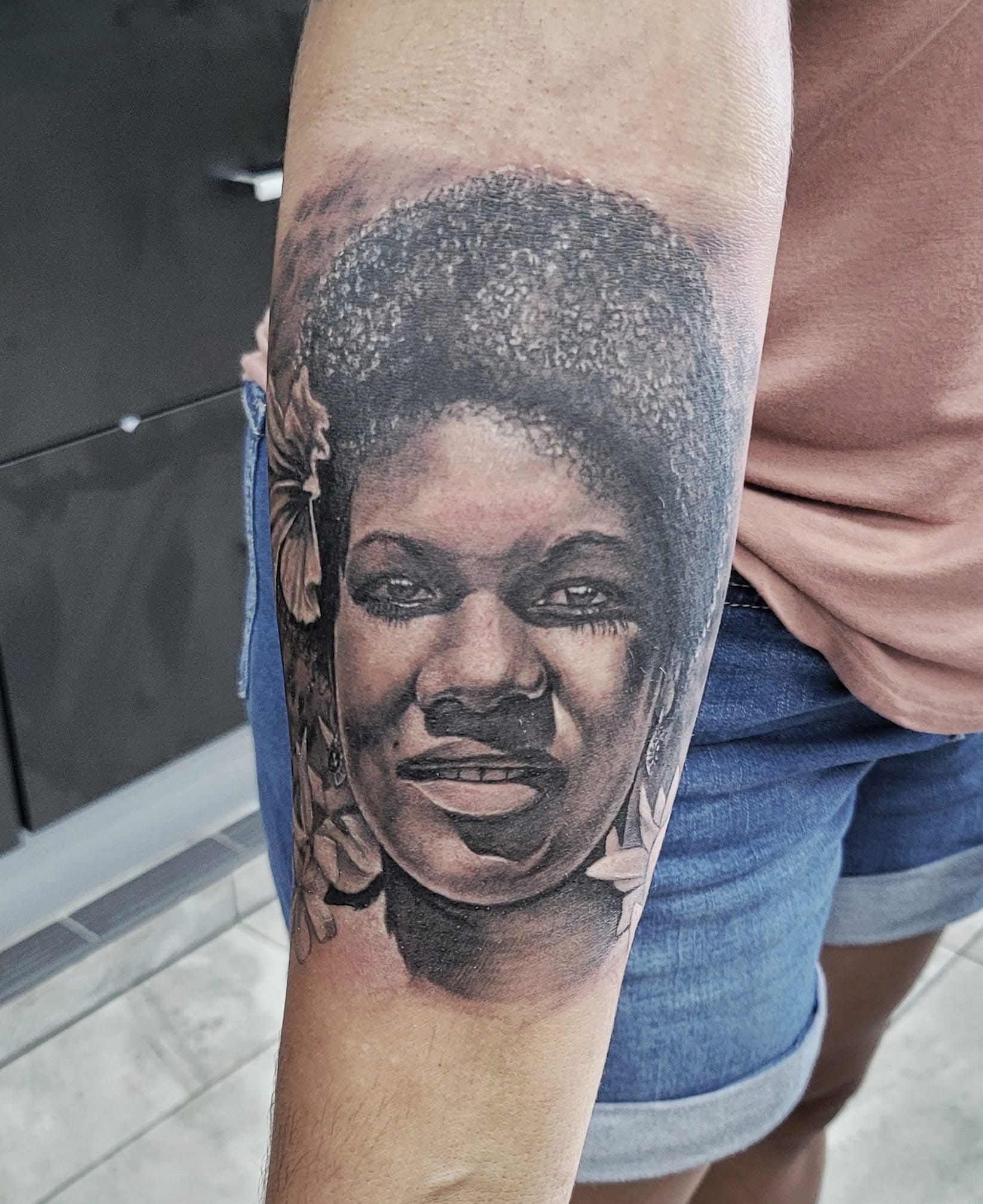 Tattoo portrait of a woman's face, dark hair, on a person's forearm, in black and gray ink. — Whitsunday Tattooing Airlie Beach in Whitsundays, QLD