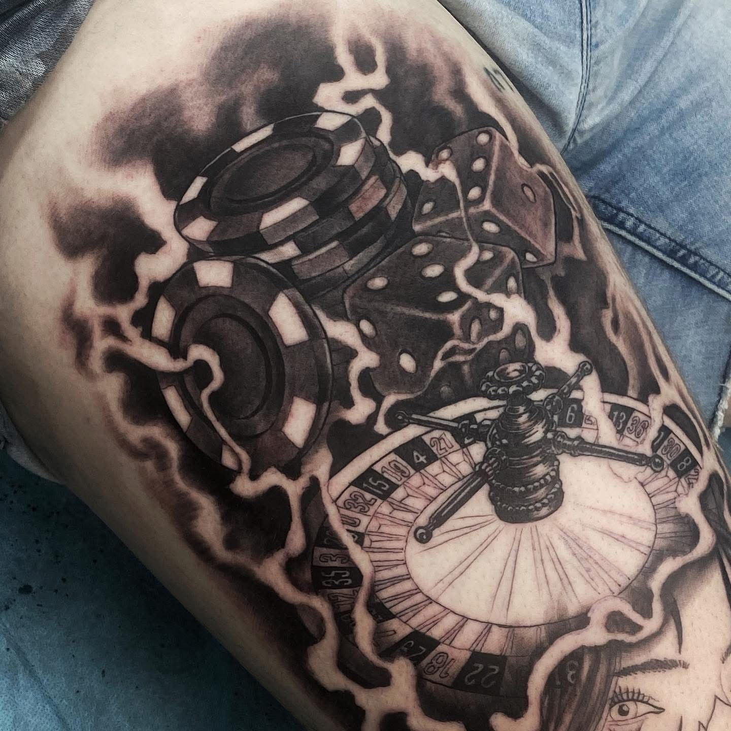 Tattoo of casino elements: poker chips, dice, roulette wheel, with dark smoky shading. — Whitsunday Tattooing Airlie Beach in Whitsundays, QLD