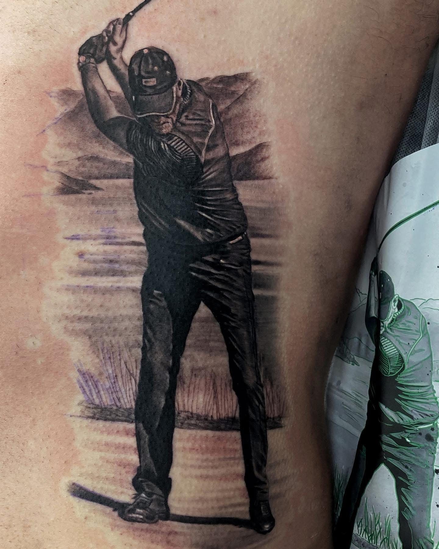 Tattoo of a person in a golf swing with a landscape background, rendered in black and gray ink. — Whitsunday Tattooing Airlie Beach in Whitsundays, QLD