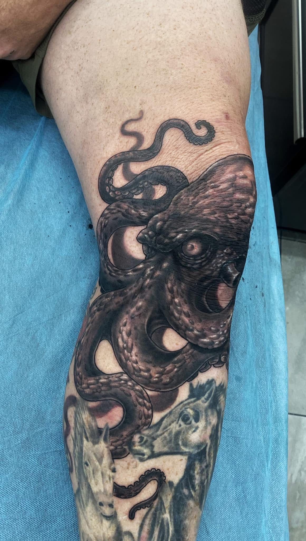 Tattoo of an octopus on a knee and lower leg. Black ink, detailed texture. — Whitsunday Tattooing Airlie Beach in Whitsundays, QLD