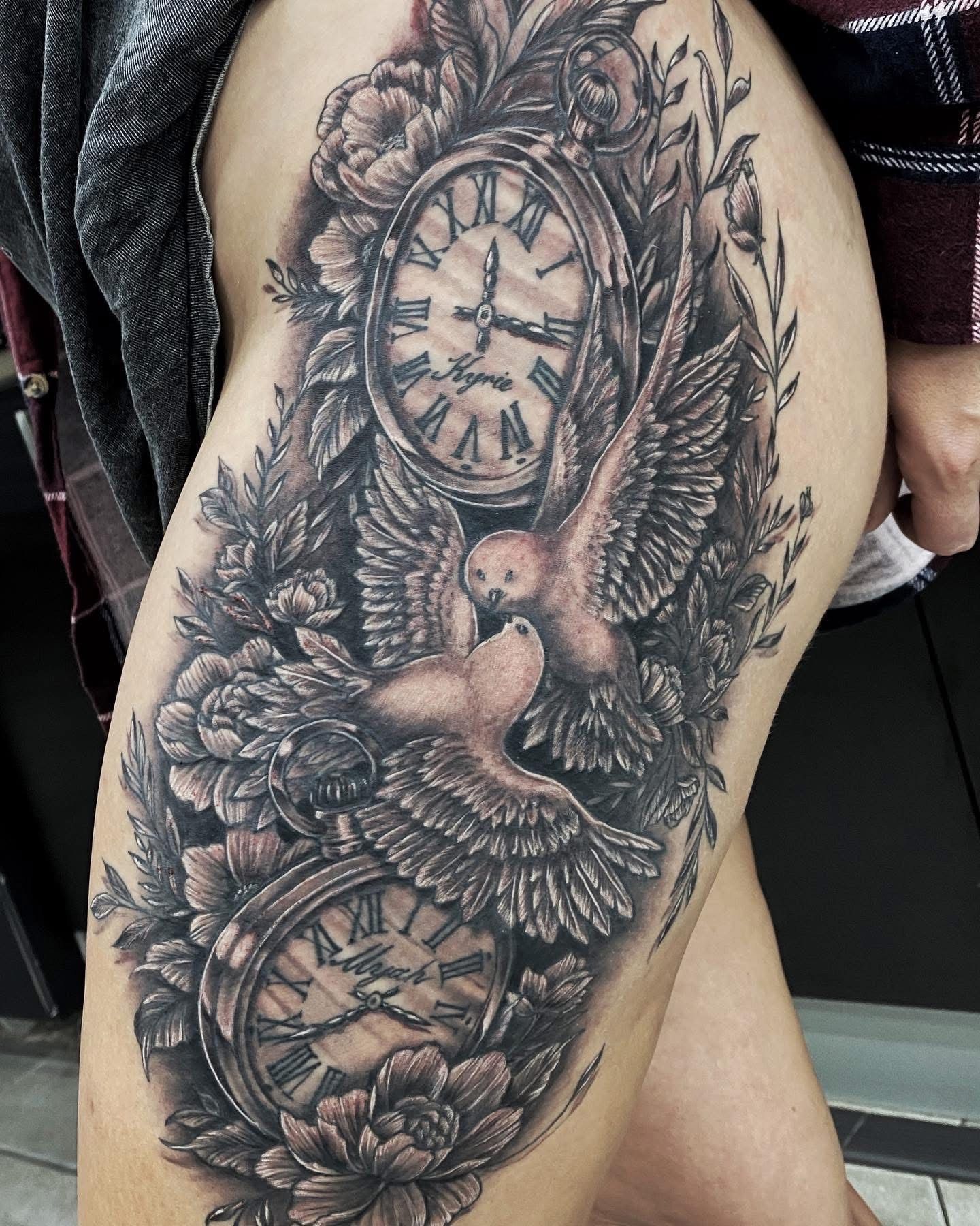 Tattoo of two pocket watches and two doves surrounded by flowers and leaves on a thigh. — Whitsunday Tattooing Airlie Beach in Whitsundays, QLD