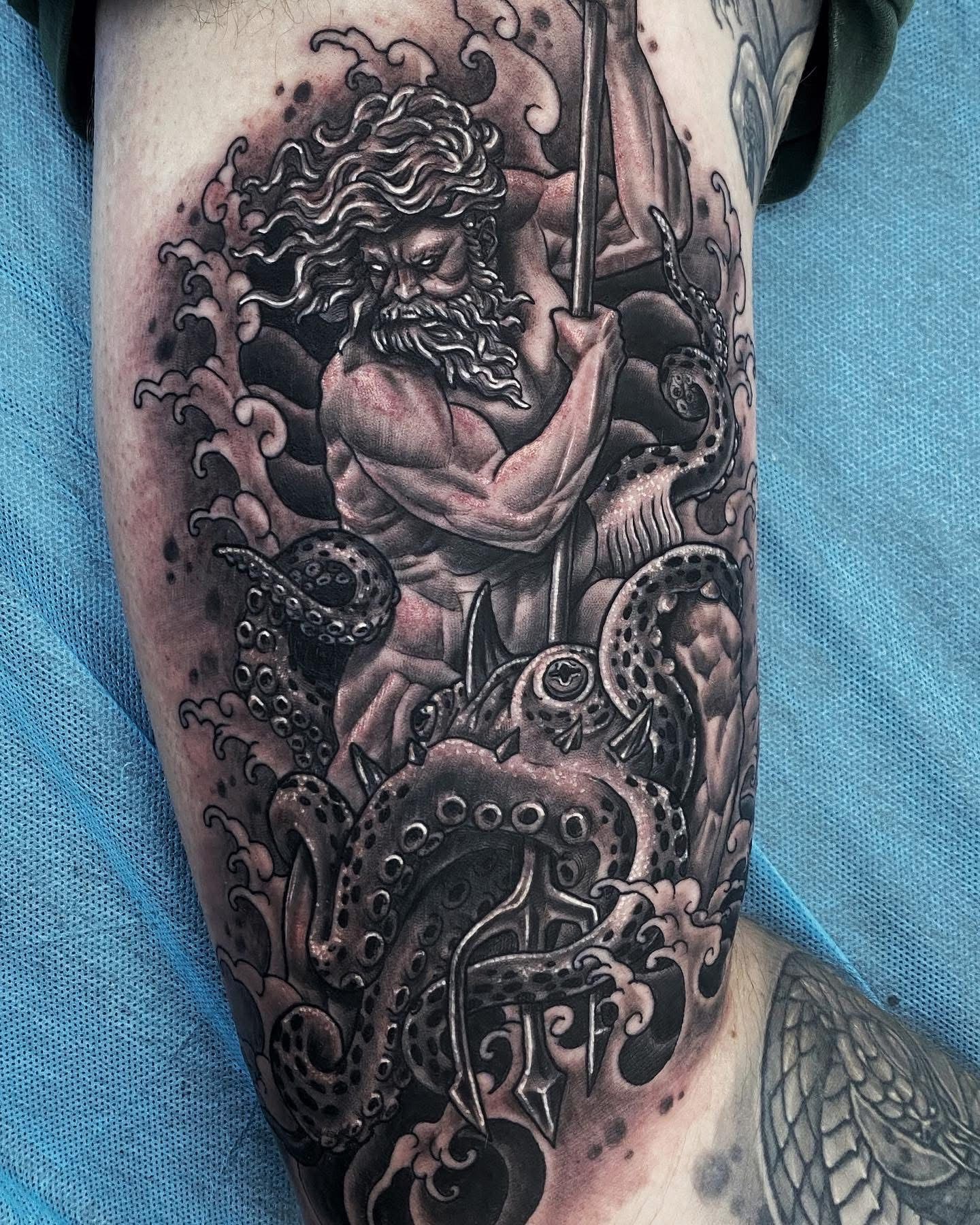 Tattoo of a muscular sea god, holding a trident, surrounded by ocean waves and octopus tentacles. — Whitsunday Tattooing Airlie Beach in Whitsundays, QLD