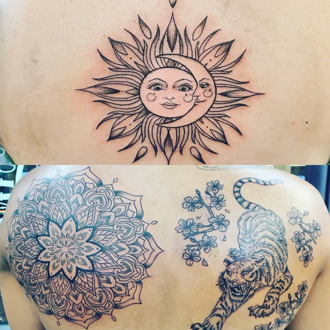 Tattooed back: Sun and moon, mandala, and tiger with flowers.