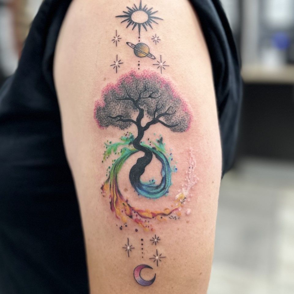 Arm tattoo: Tree with colorful swirling water, planets, stars, sun, and moon. — Whitsunday Tattooing Airlie Beach in Whitsundays, QLD