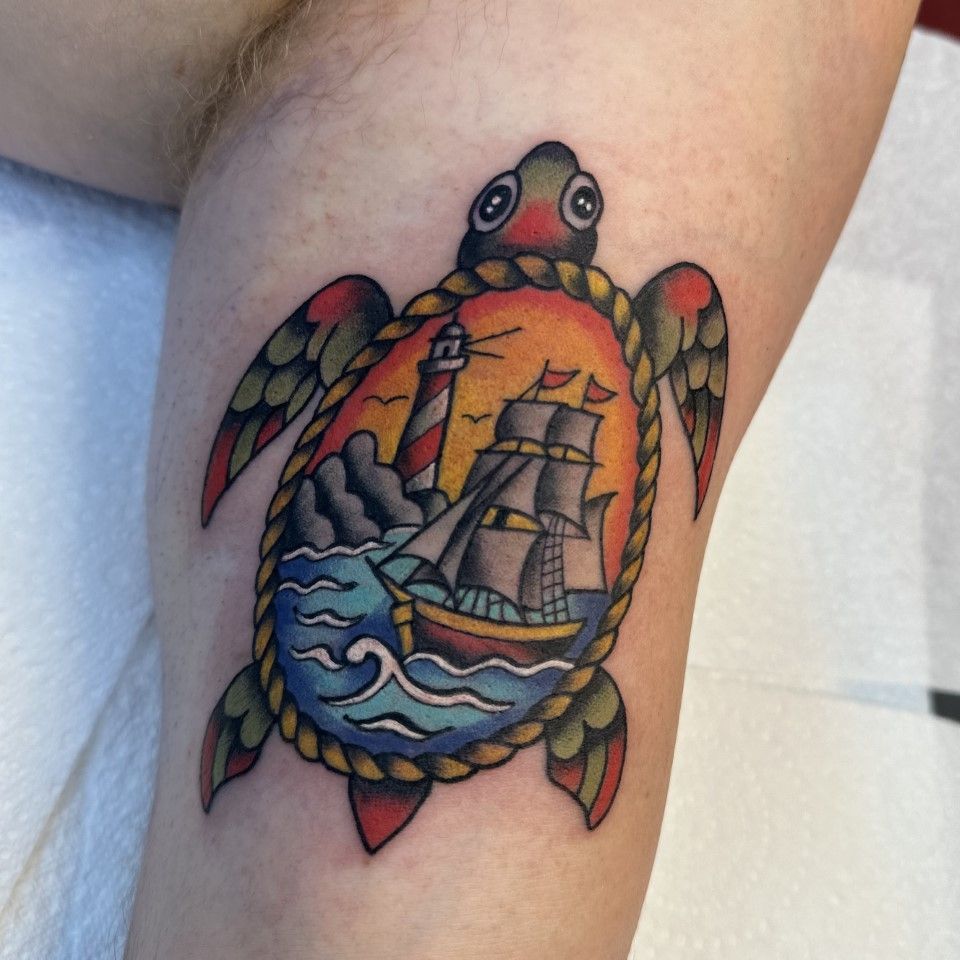 Colorful turtle tattoo with a ship and lighthouse inside. — Whitsunday Tattooing Airlie Beach in Whitsundays, QLD