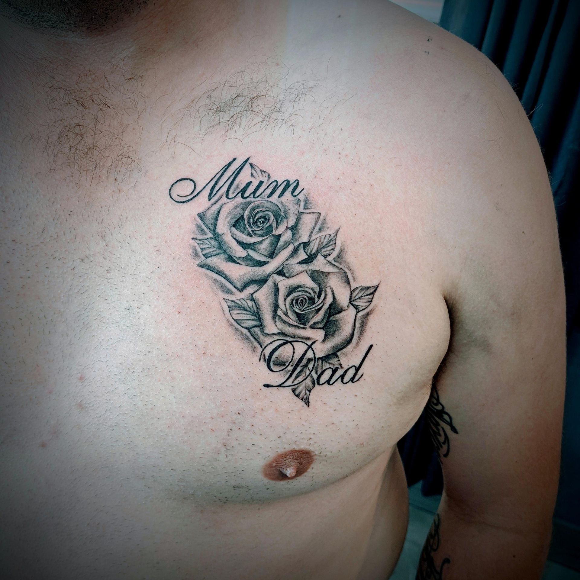 Chest tattoo: two roses with