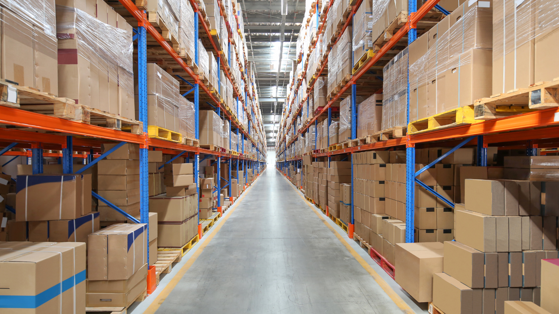 A warehouse filled with lots of cardboard boxes on shelves.