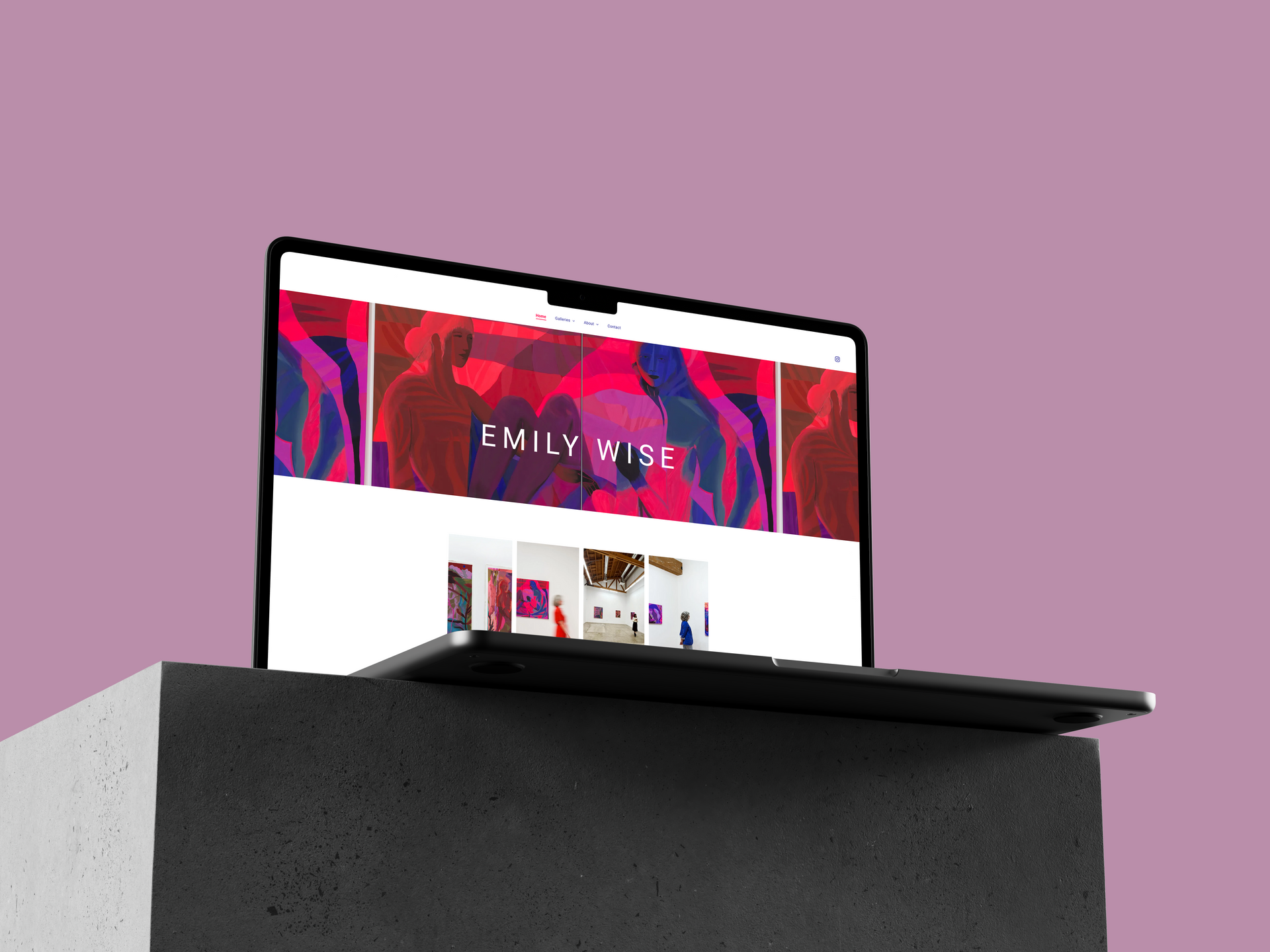 Laptop displaying Emily Wise website on a stone block, purple background.