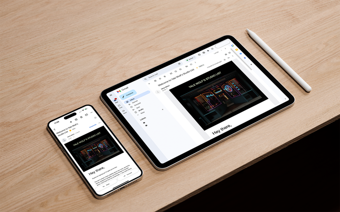 Hand holding a white envelope against a yellow background.