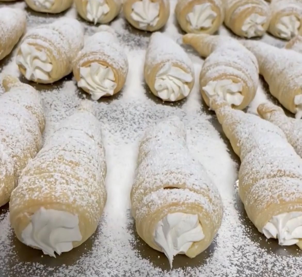 A bunch of pastry cones covered in powdered sugar