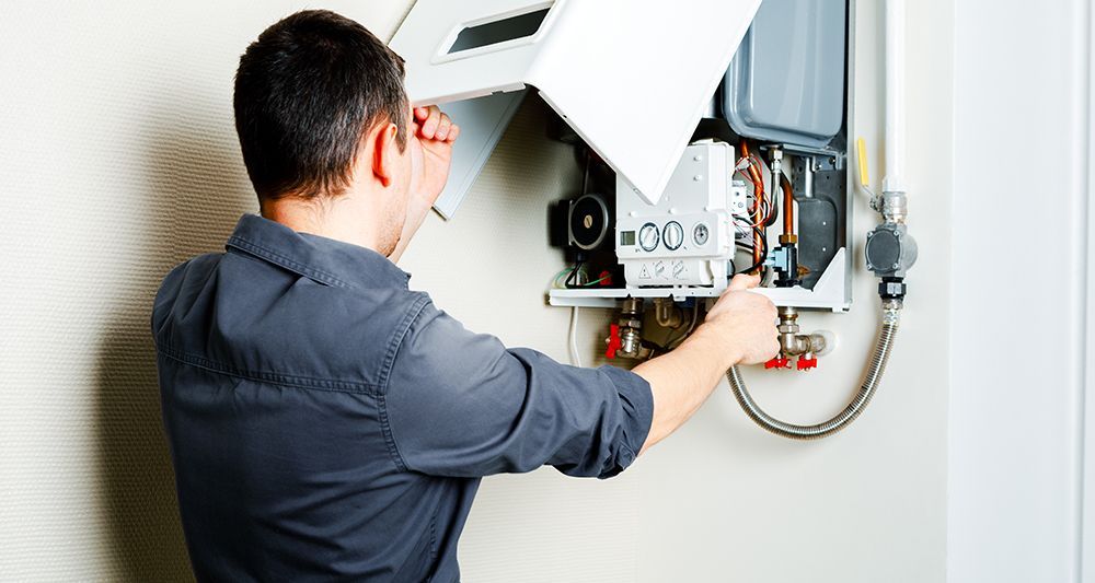 Gas Safe engineer performing boiler servicing in a London home