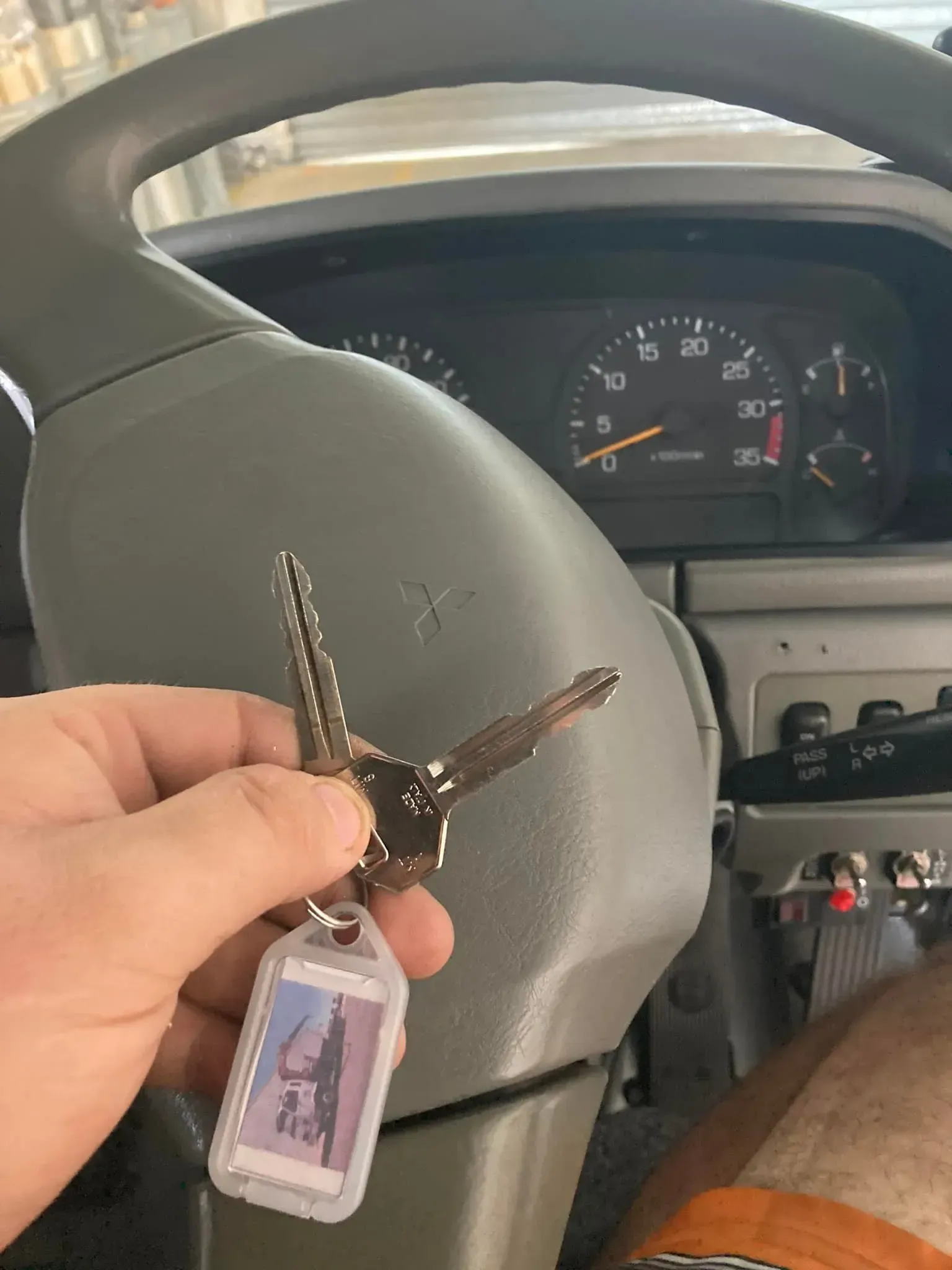 Hand Holding a Set of Keys in A Car — Nq Locksmiths in Charters Towers, QLD