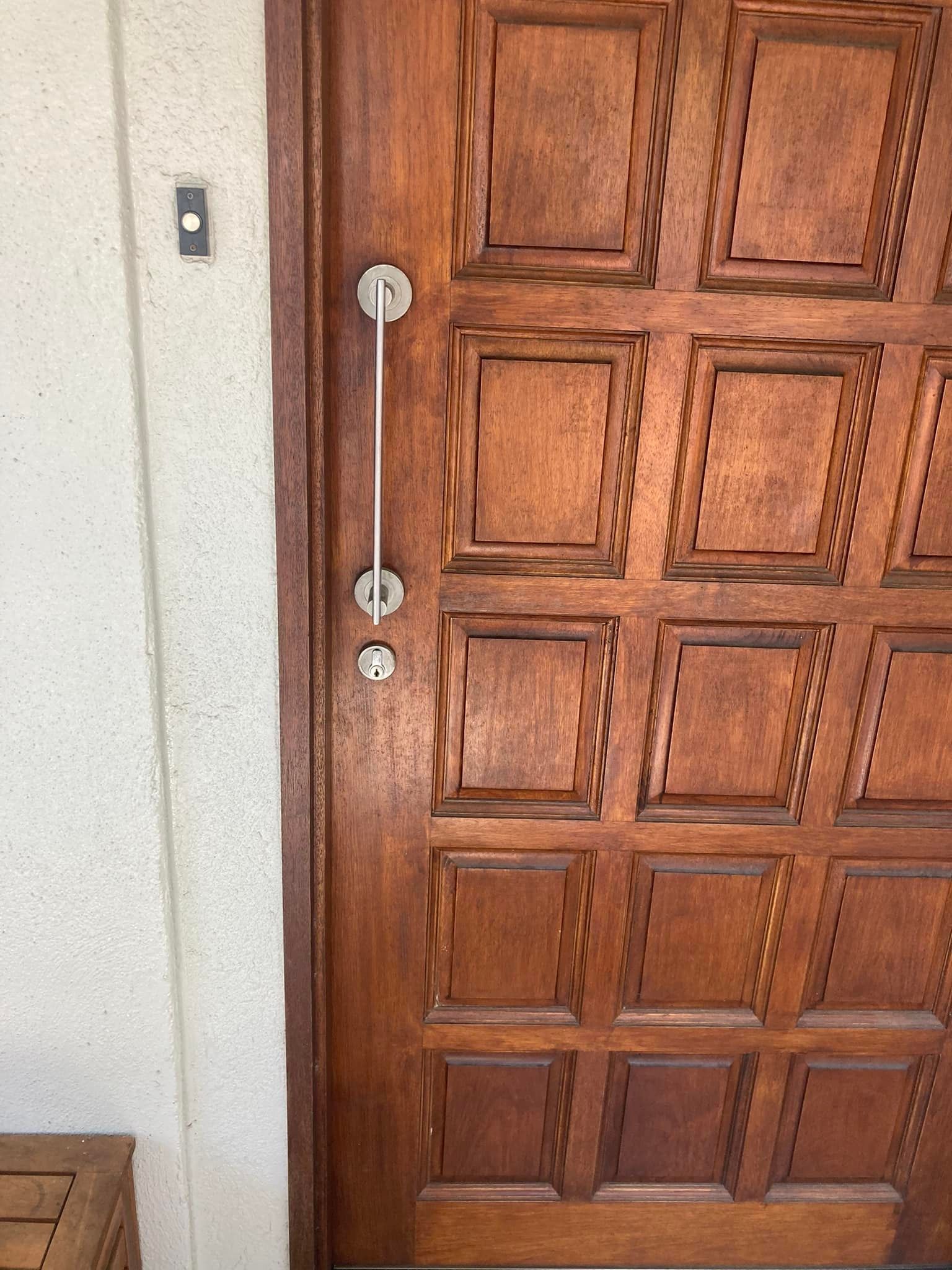 Wooden Door with Square Panels and A Long, Vertical Handle — Nq Locksmiths In Kirwan, QLD