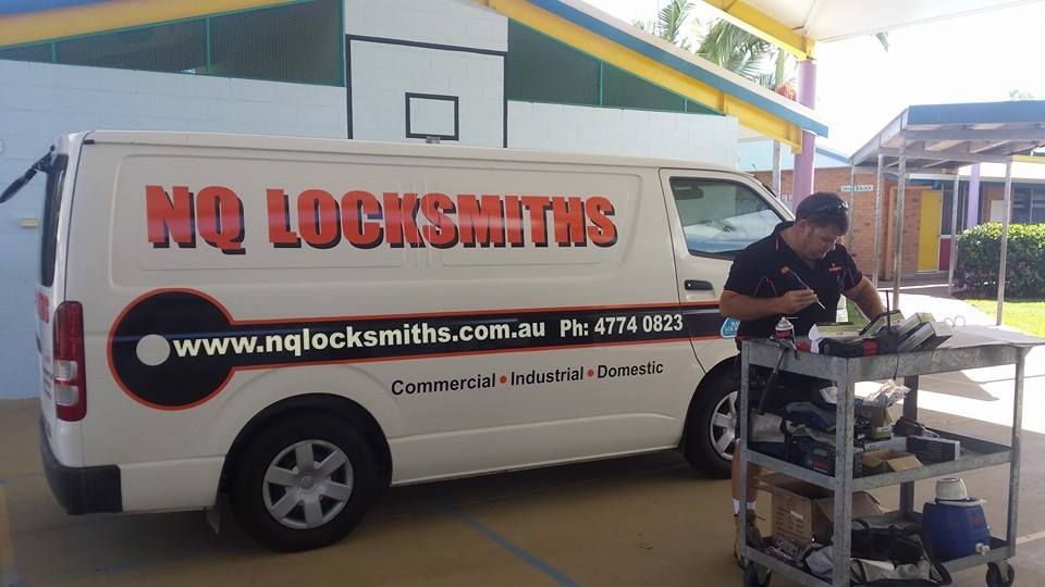 Hand Holding Mercedes Key in Front of A Steering Wheel — Nq Locksmiths In Kirwan, QLD