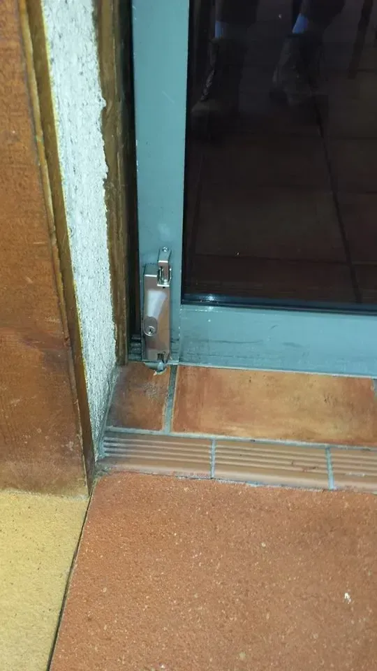 Silver Door Frame with A Latch and Brick Floor — Nq Locksmiths In Kirwan, QLD