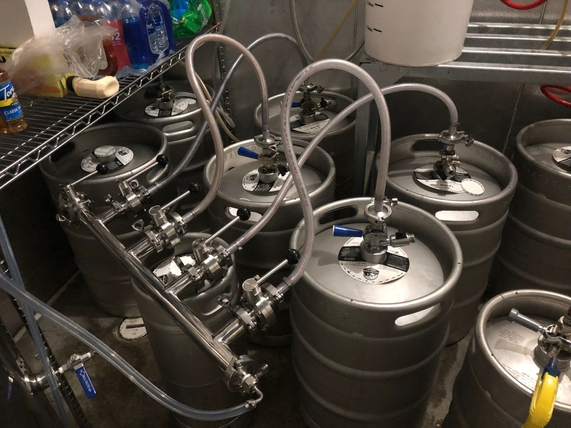 A bunch of kegs are stacked on top of each other