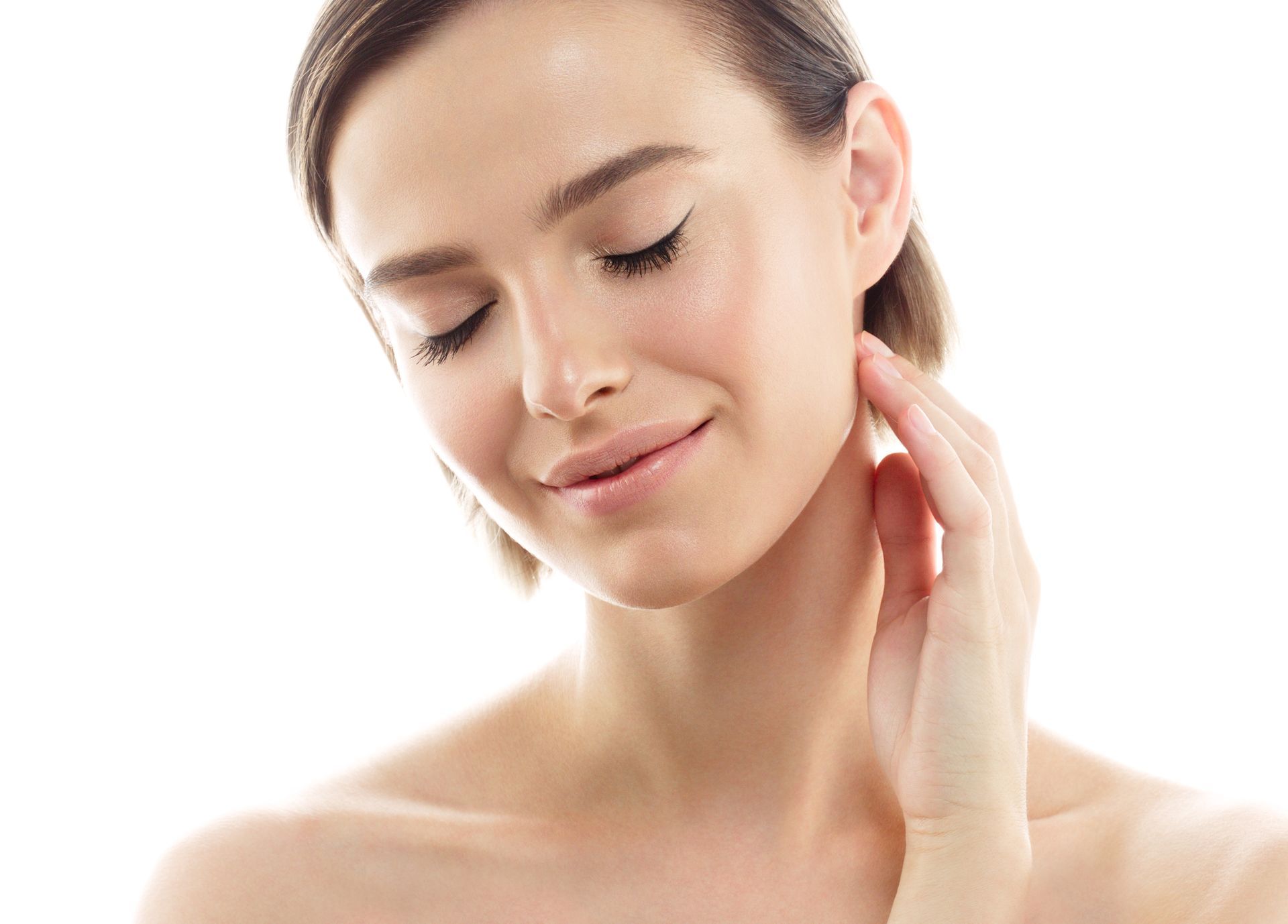 A person with their eyes closed gently touches their neck, showcasing smooth skin against a clean, white background.