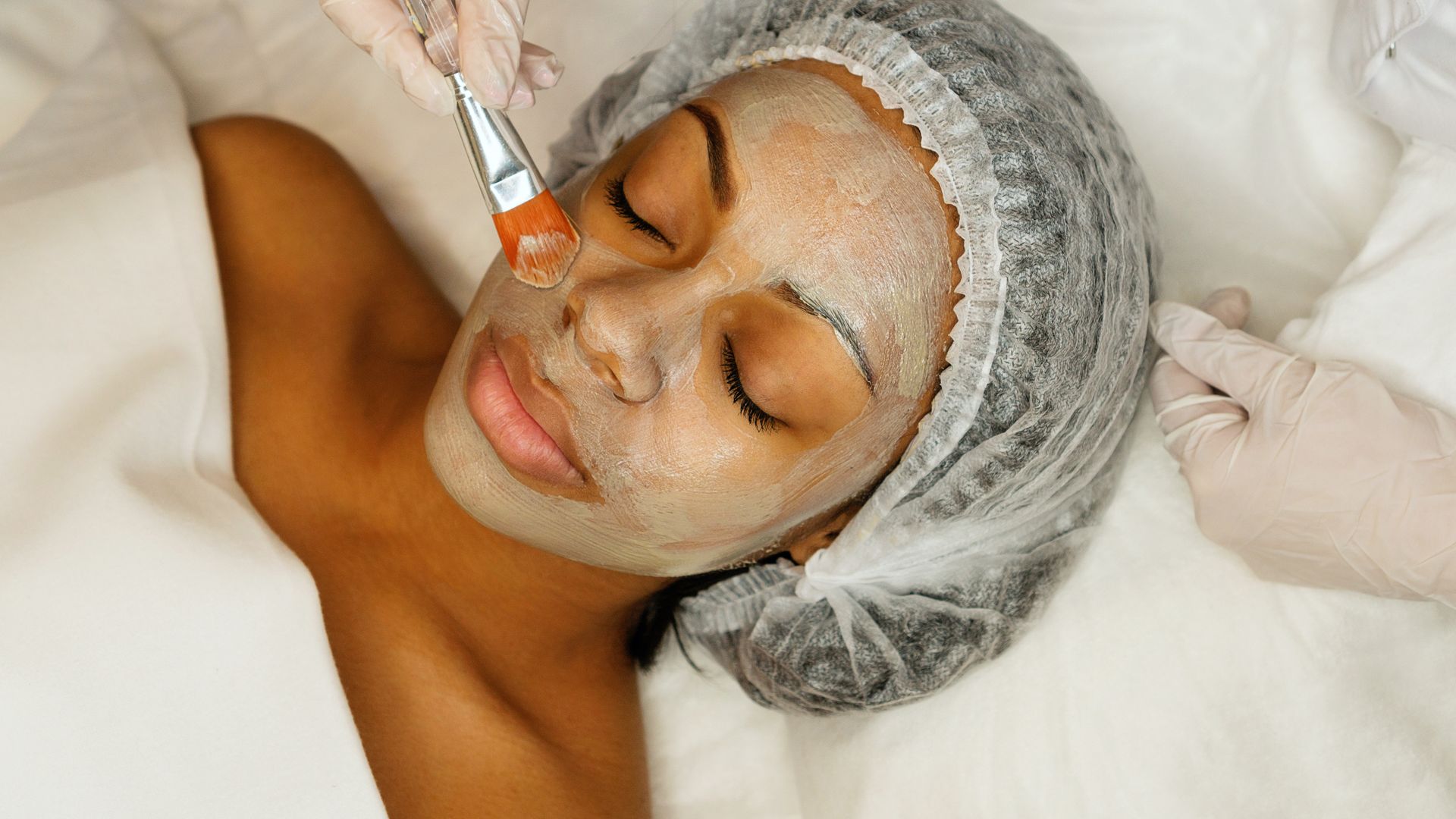 A woman is getting a facial treatment at a spa.