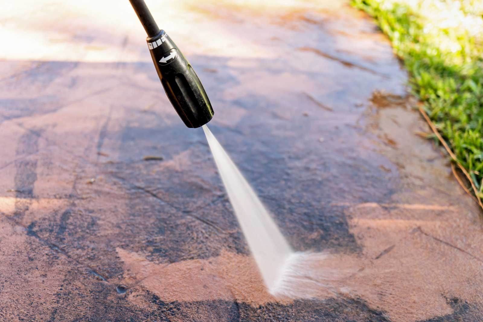 Pressure washer cleaning a concrete surface.
