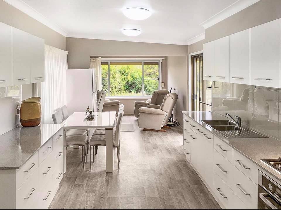 White Kitchen with Wood Style Flooring — Cabinet Makers In Tamworth, NSW