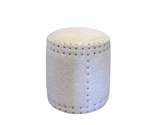 White cylindrical upholstered ottoman with visible stitching.