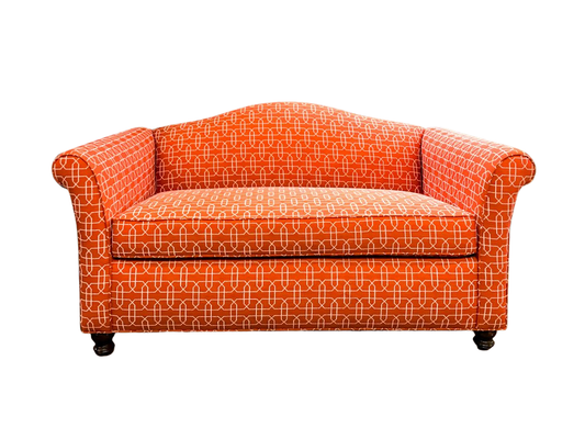 Orange patterned loveseat with rounded arms and back, black legs, set against white background.