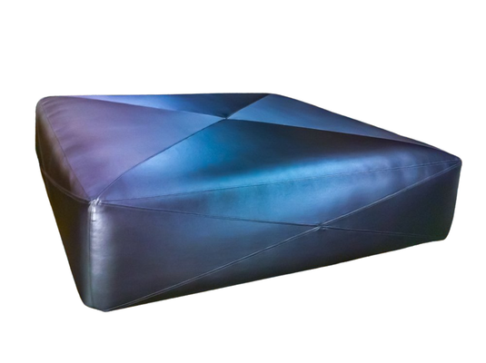 Blue geometric leather ottoman, reflecting light.