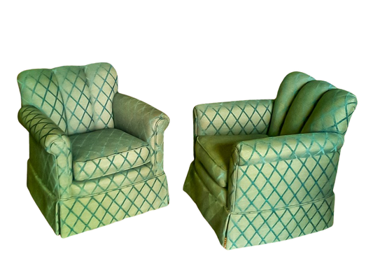 Two green upholstered armchairs with diamond pattern.